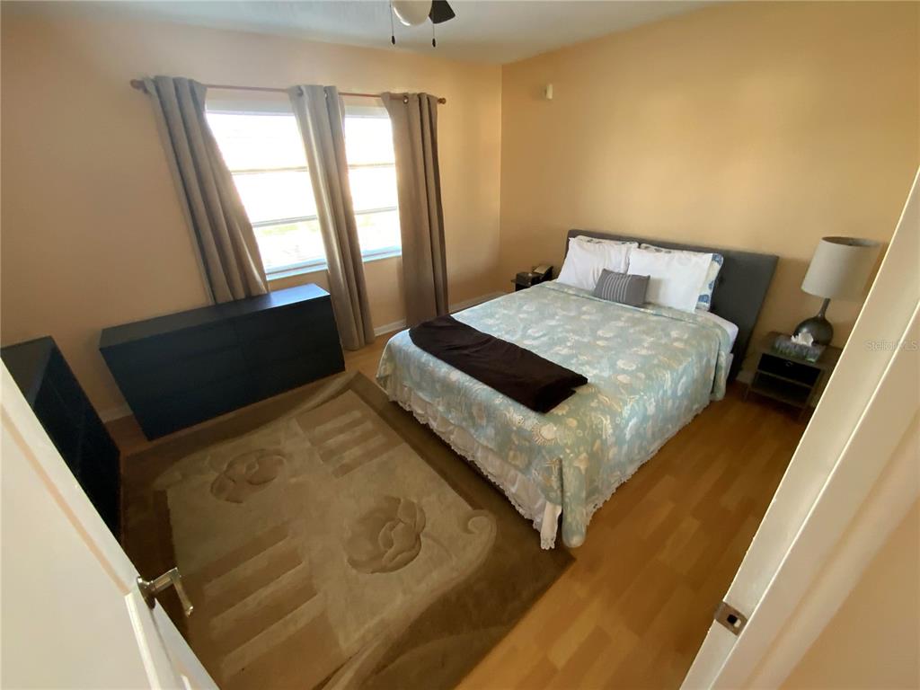 239 South McMullen Booth Road, Unit 38 Clearwater, FL 33759 - Photo 25 of 32 a bedroom with a bed and window