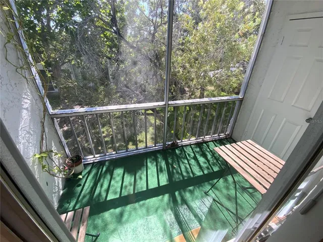 a room with pool table and windows