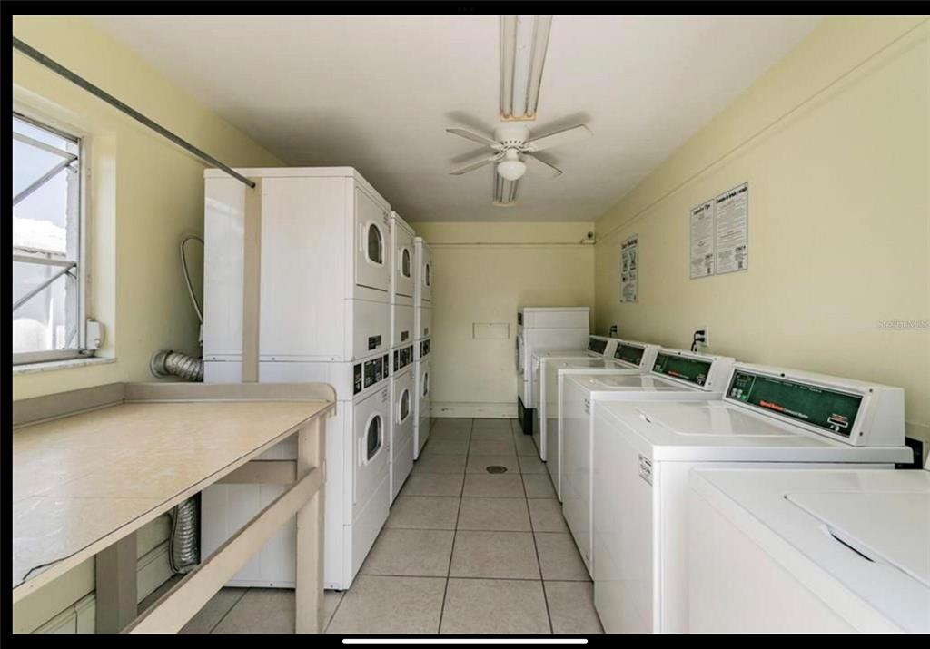 239 South McMullen Booth Road, Unit 38 Clearwater, FL 33759 - Photo 32 of 32 a view of washer and dryer with kitchen in the background