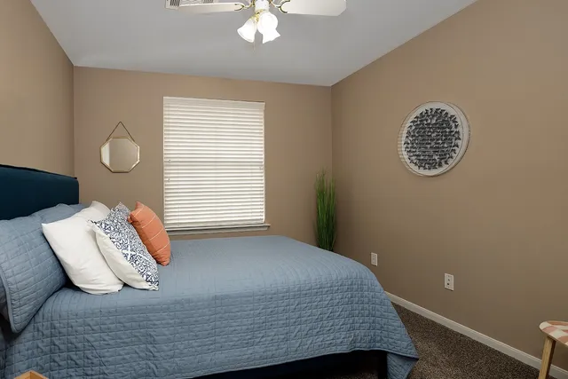 a bedroom with a bed and a window