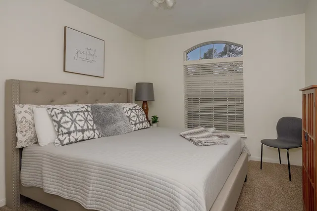 a bedroom with a bed and chair