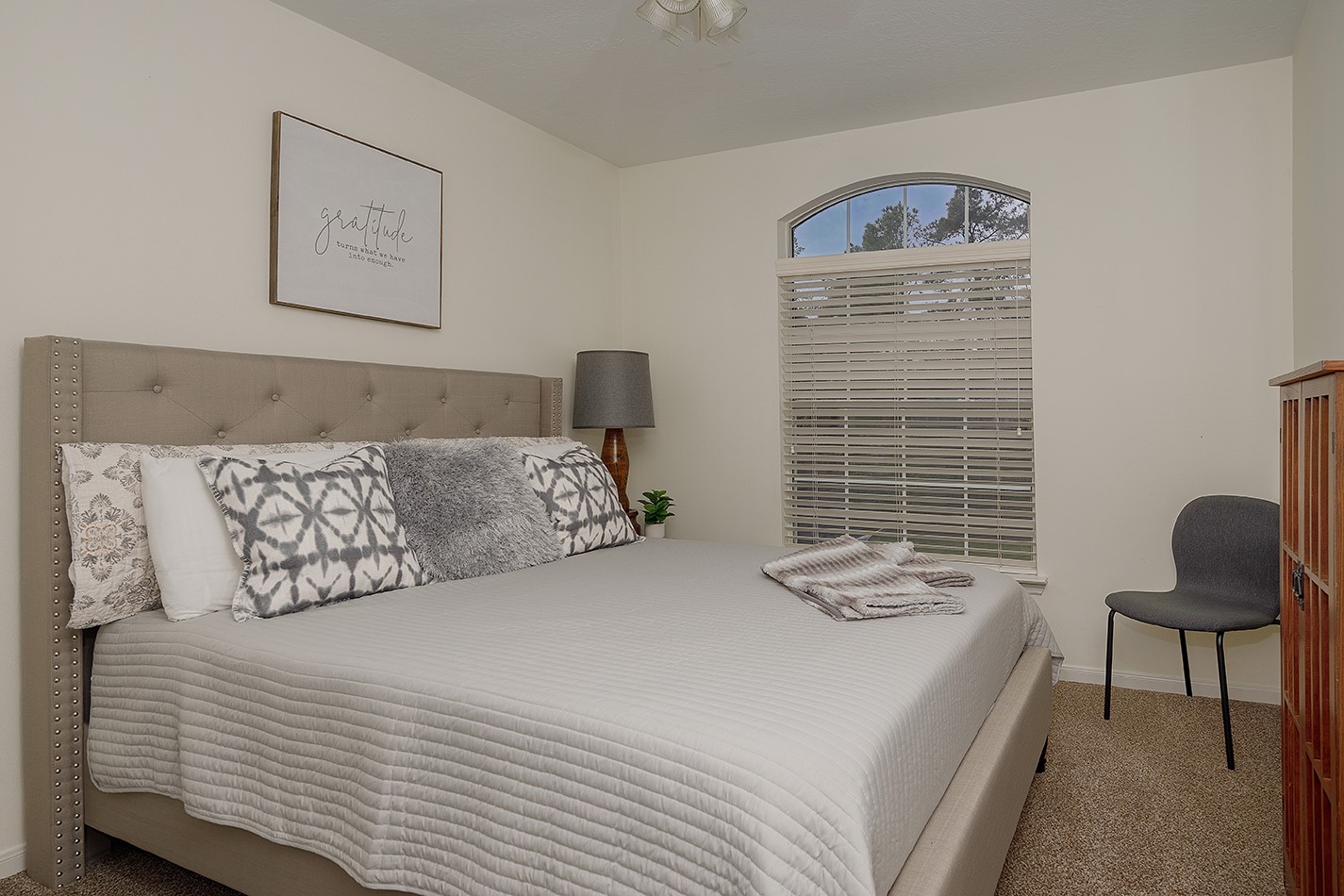 110 North Valley Oaks Circle The Woodlands, TX 77382 - Photo 22 of 29 a bedroom with a bed and chair