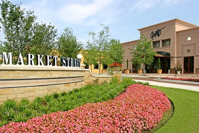 a view of a swimming pool with a bench in front of main door