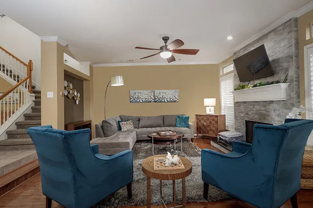 a living room with furniture a fireplace and a flat screen tv