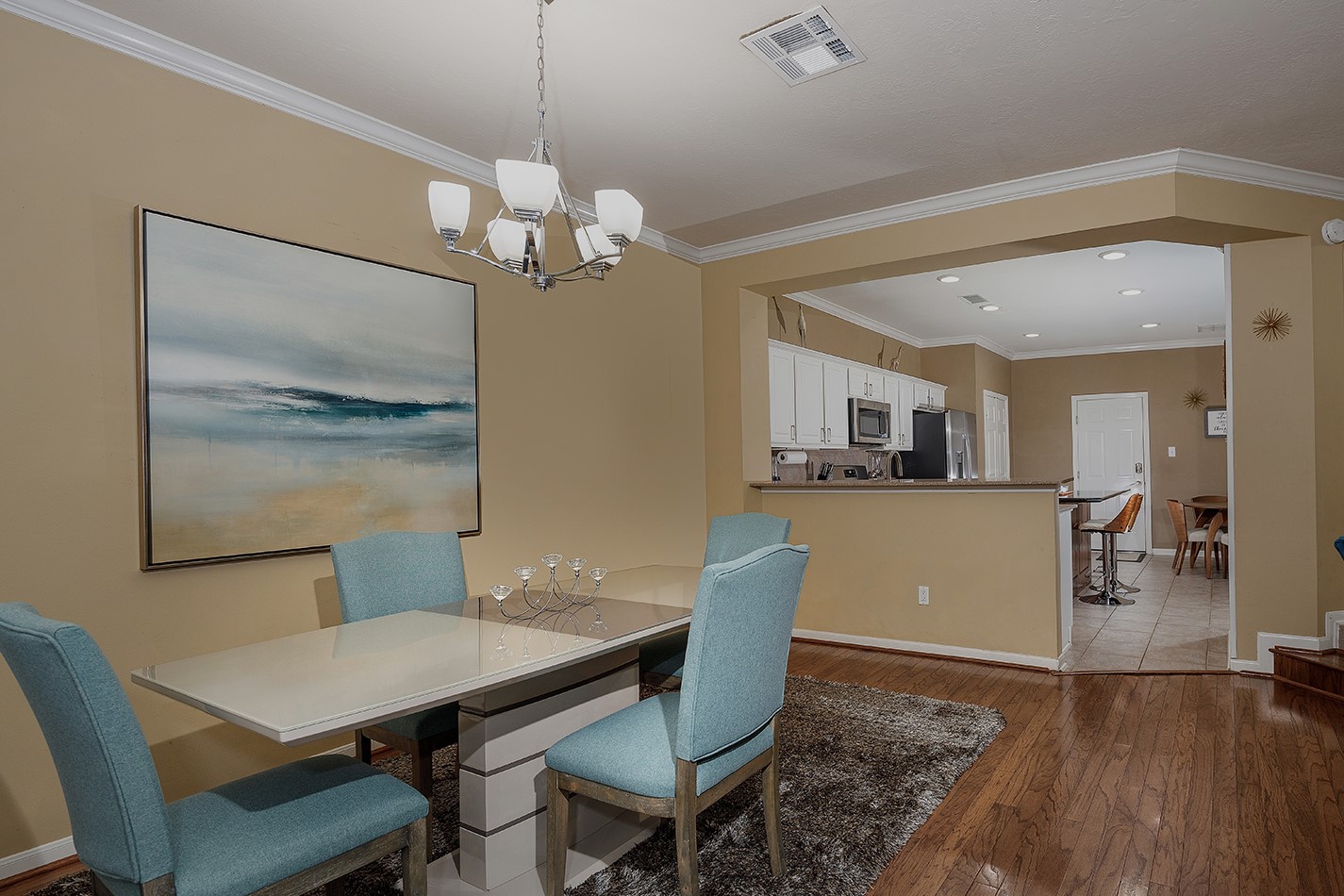 110 North Valley Oaks Circle The Woodlands, TX 77382 - Photo 7 of 29 a view of a dining room with furniture a chandelier and wooden floor