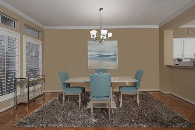 a dining room with furniture a rug and wooden floor