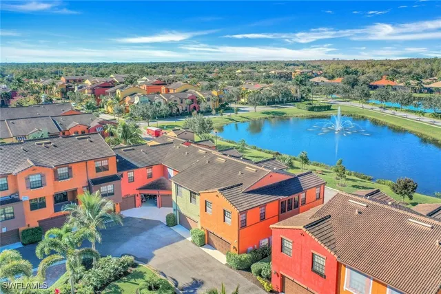 an aerial view of residential houses with outdoor space and ocean view