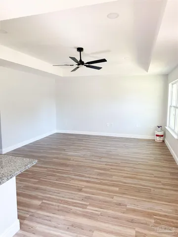a view of a room with wooden floor