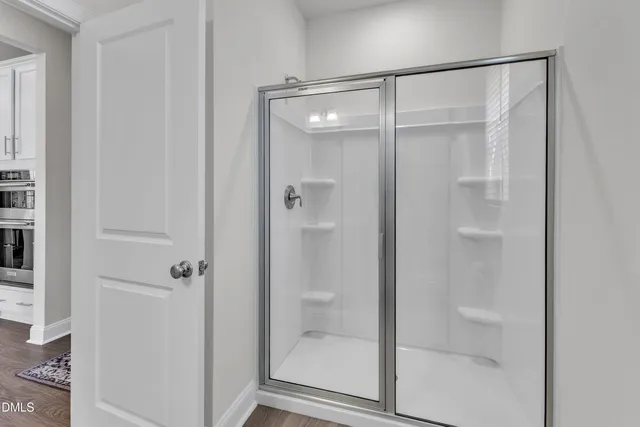 a bathroom with a sink toilet vanity and shower