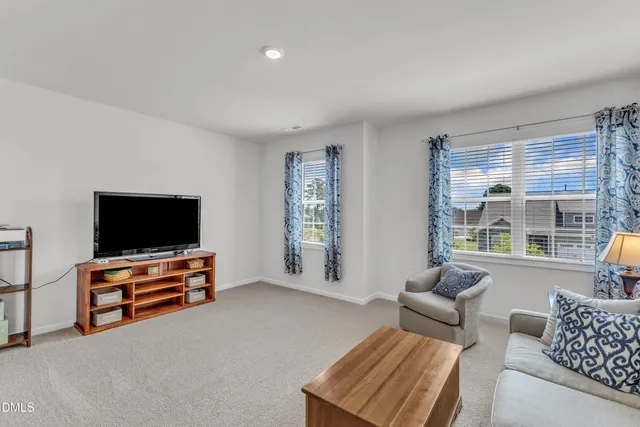 a living room with furniture and a lamp