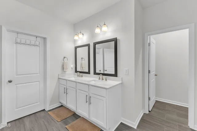 a bathroom with a double vanity sink mirror and double