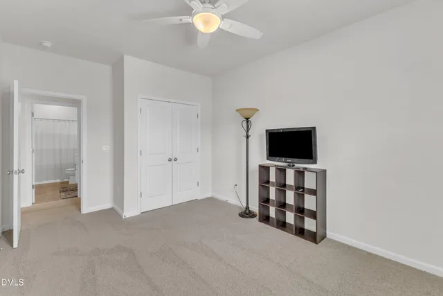 an empty room with windows and cabinet