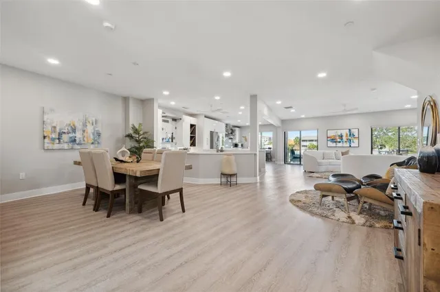 a living room with furniture a flat screen tv and a floor to ceiling window