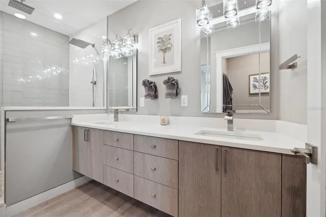 a bathroom with a sink a light fixture and a mirror