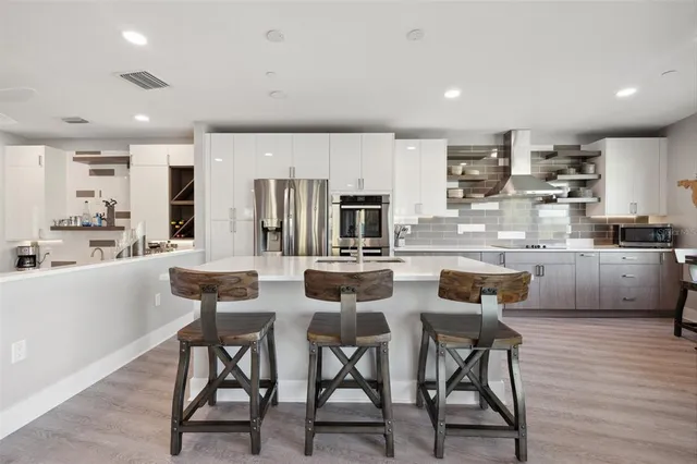 a kitchen with a sink cabinets and wooden floor