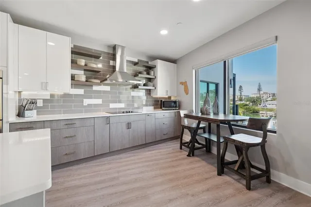 a kitchen with lots of wooden furniture a sink appliances and cabinets