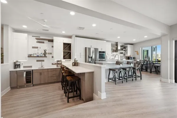 a kitchen with kitchen island a table and chairs in it