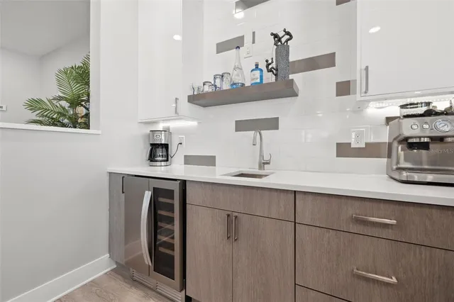 a living room with furniture a mirror and a table