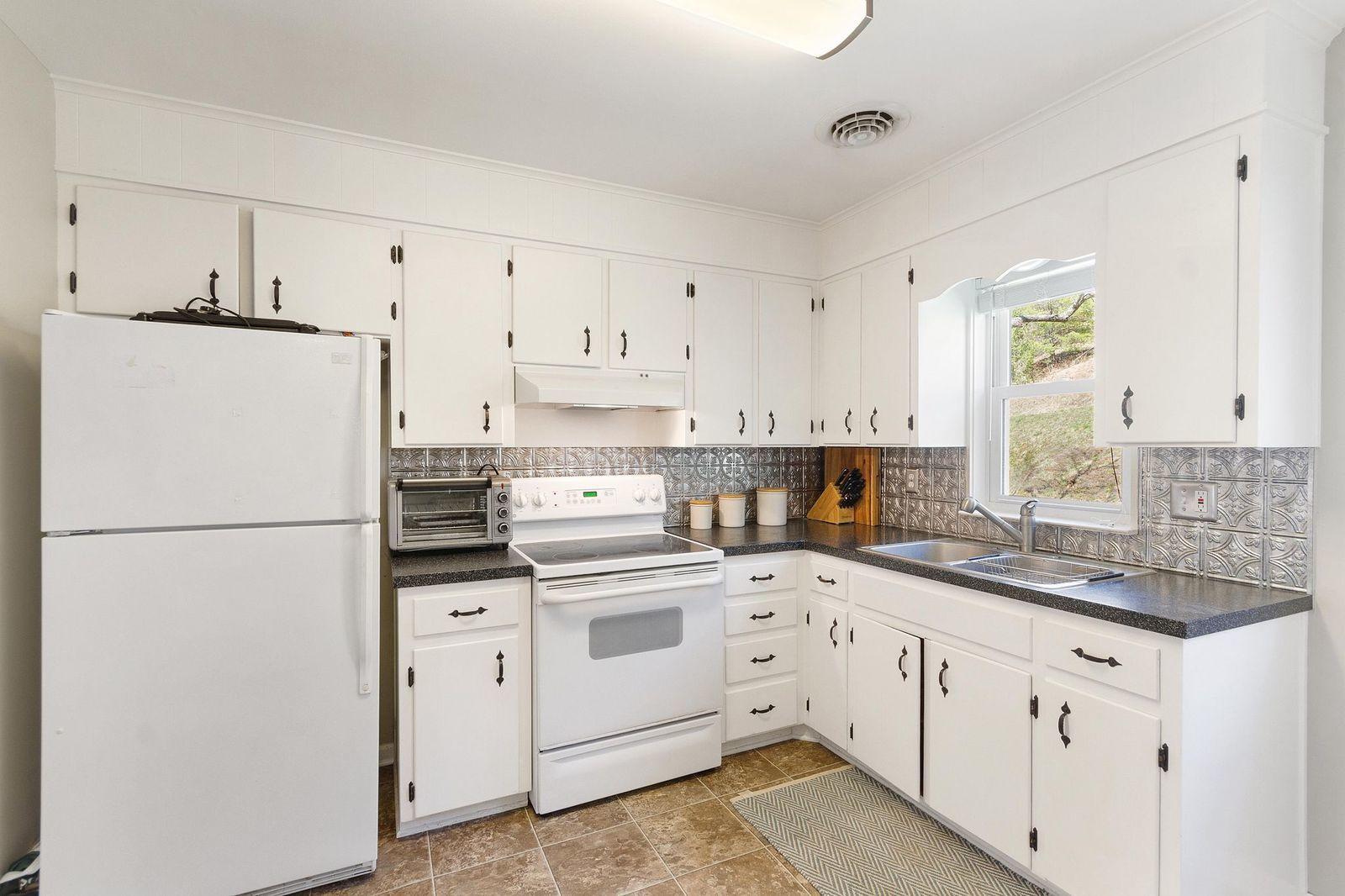 3600 Pilot Road Riner, VA 24149 - Photo 14 of 48 a kitchen with white cabinets white appliances and sink