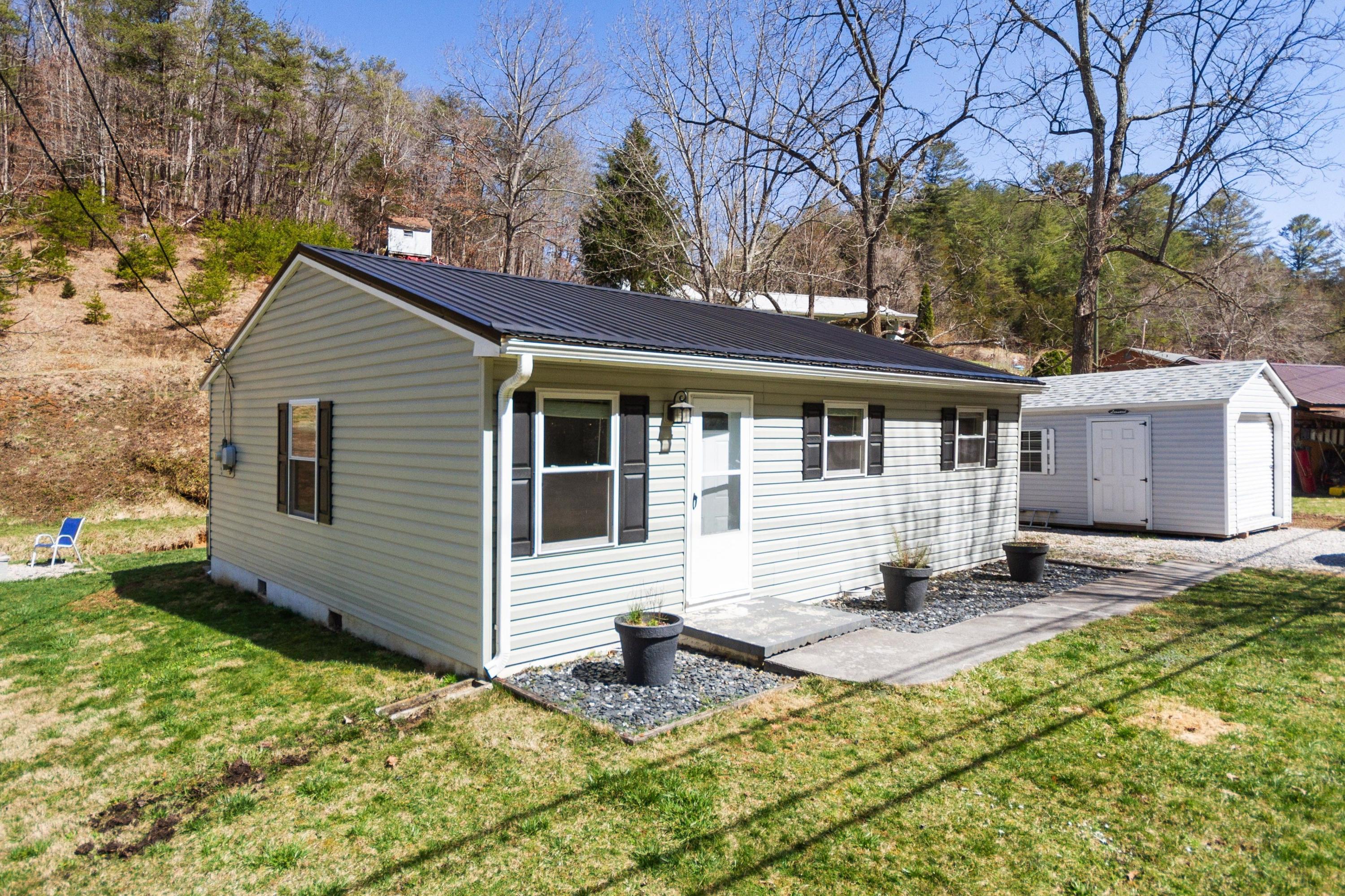 3600 Pilot Road Riner, VA 24149 - Photo 8 of 48 a backyard of a house with yard and outdoor seating