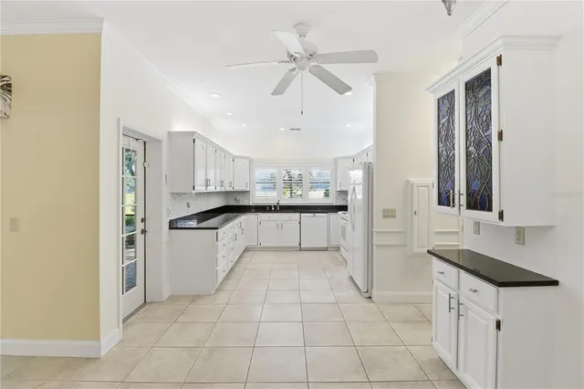 a kitchen with granite countertop a sink and cabinets