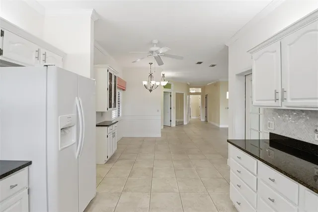 a view of a kitchen with a sink and refrigerator