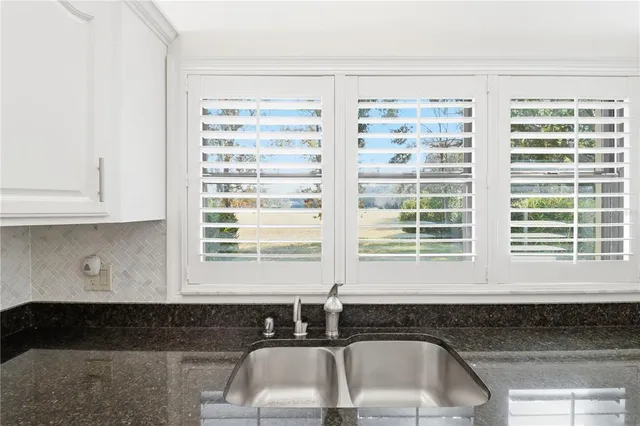 a kitchen that has a sink and a window in it
