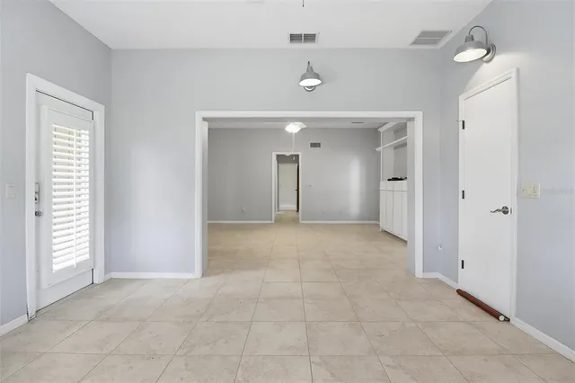 a view of an empty room and a window