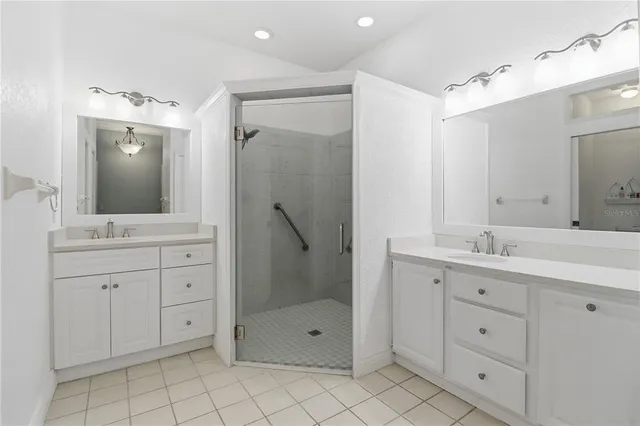 a spacious bathroom with a granite countertop sink mirror and shower