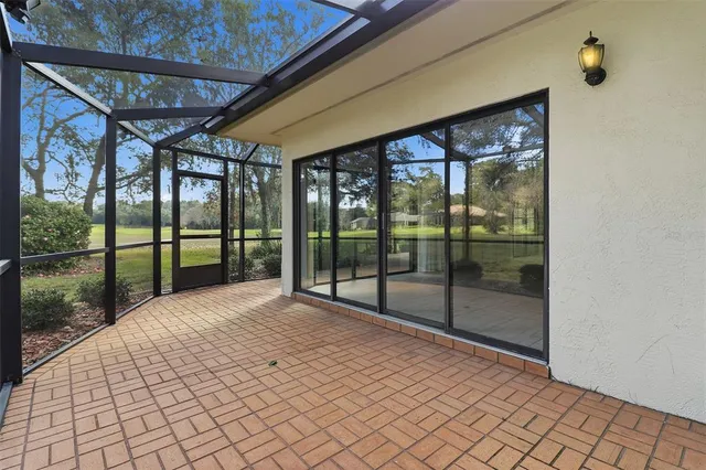 a view of a porch with a floor to ceiling window and wooden floor