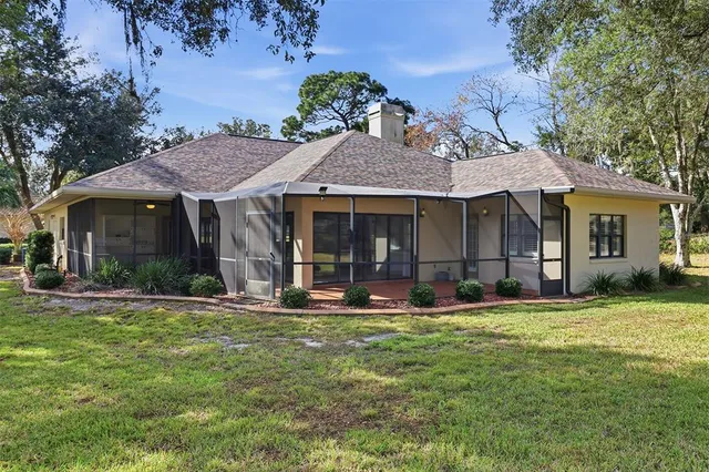 a front view of a house with a garden and trees