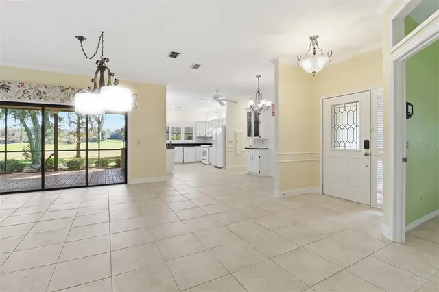 a view of a hallway with chandelier and chandelier