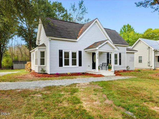 a view of a livingroom with wooden floor and a window
