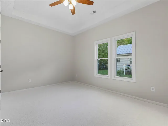 a view of a backyard with a garden and trees