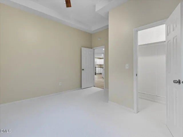 a view of a house with a yard and large tree