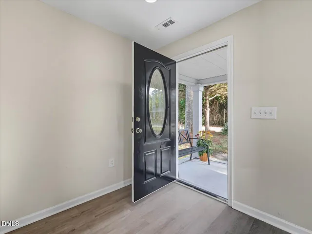 a kitchen with stainless steel appliances kitchen island granite countertop a stove a sink a dining table and chairs