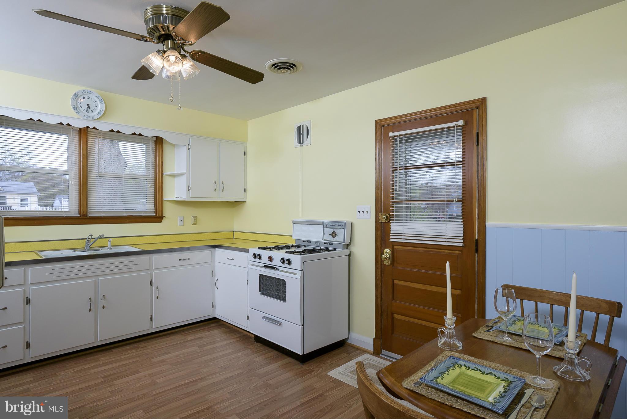 871 Elmhurst Road Severn, MD 21144 - Photo 8 of 28 a kitchen with stainless steel appliances granite countertop a stove and a refrigerator