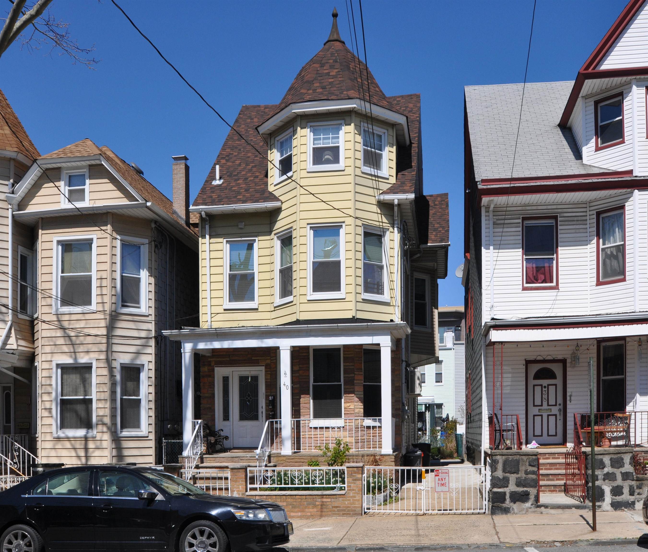 40 47th Street, Unit 2 Weehawken, NJ 07086 - Photo 1 of 8 a front view of a residential apartment building with a yard