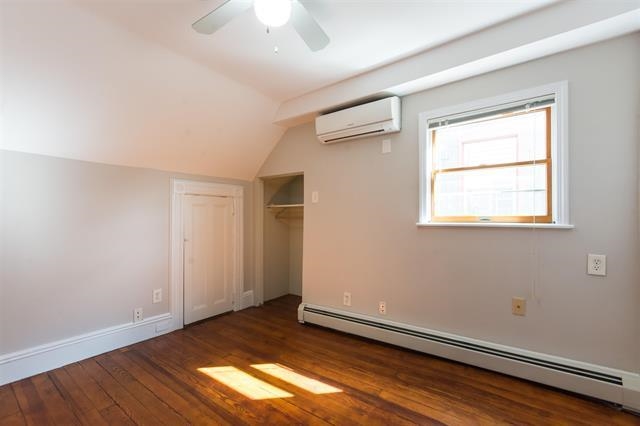 40 47th Street, Unit 2 Weehawken, NJ 07086 - Photo 5 of 8 an empty room with wooden floor and windows