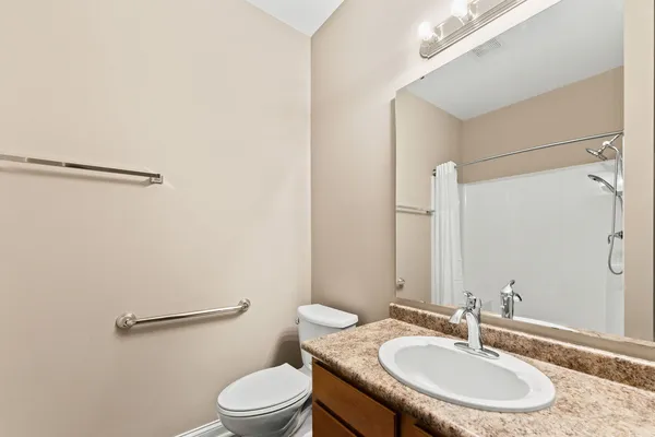 a bathroom with a sink toilet a mirror and vanity