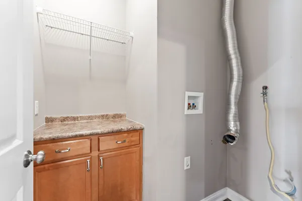 a view of a storage and utility room with closet