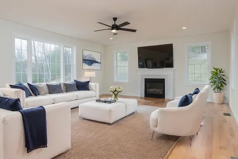a living room with furniture fireplace and a flat screen tv