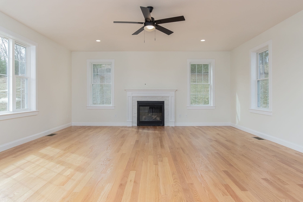 76 Robin Hill Road Groton, MA 01450 - Photo 12 of 42 an empty room with windows and fireplace