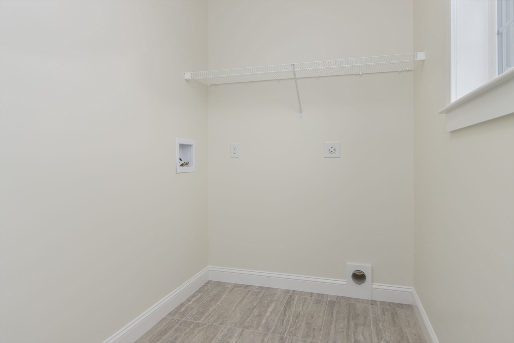 76 Robin Hill Road Groton, MA 01450 - Photo 16 of 42 a view of a room with racks on the wall