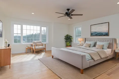 a spacious bedroom with a bed and large windows