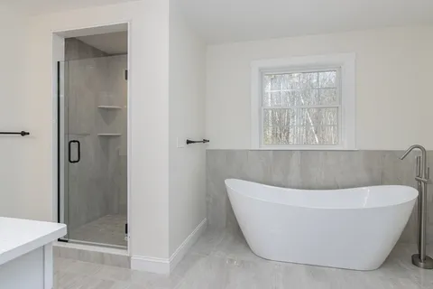a white bath tub sitting in a bathroom
