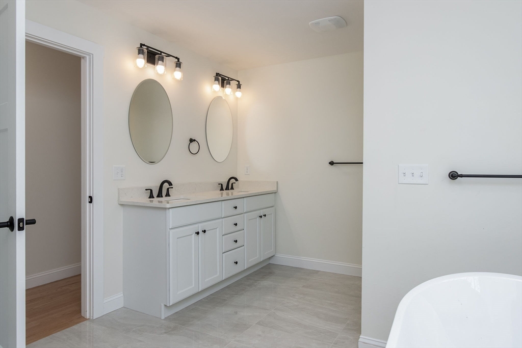 76 Robin Hill Road Groton, MA 01450 - Photo 21 of 42 a bathroom with a double vanity sink and a mirror