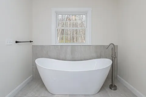 a white bath tub sitting in a bathroom