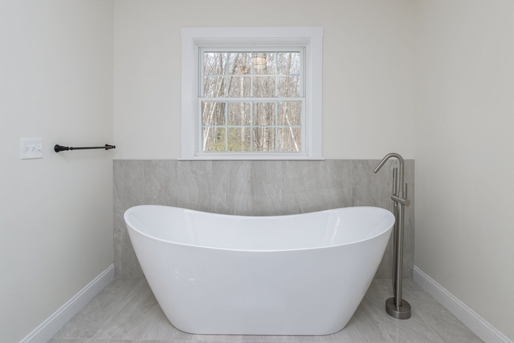 76 Robin Hill Road Groton, MA 01450 - Photo 22 of 42 a white bath tub sitting in a bathroom