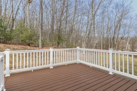a balcony with wooden floor and fence